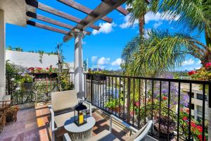 a balcony with a table and chairs and a palm tree at Best Western Plus Sunset Plaza Hotel in Los Angeles