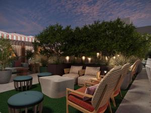 a patio with chairs and tables on a patio at Hotel Trinity, Autograph Collection in Austin