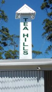 a white lighthouse sign on top of a white fence at Tea Hills Bungalow in Hatton