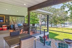a screened in porch with a table and chairs at Red House - Lake Views - Outdoor Pool in Kimberling City