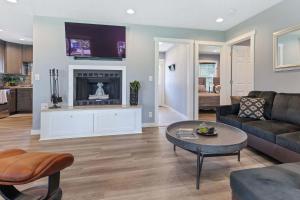 a living room with a couch and a table at Red House - Lake Views - Outdoor Pool in Kimberling City