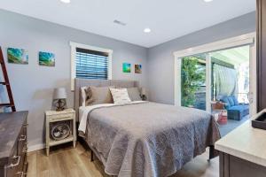 a bedroom with a bed and a sliding glass door at Red House - Lake Views - Outdoor Pool in Kimberling City