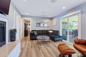 a living room with a couch and a table at Red House - Lake Views - Outdoor Pool in Kimberling City +43 photos