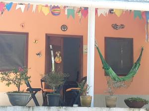 a house with a hammock outside of it at Abelha & Peixe Boi in Santo Amaro