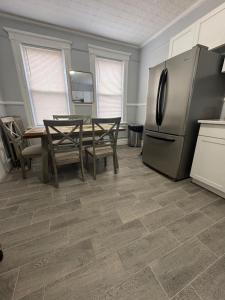 a kitchen with a table and a refrigerator at Hillside Appartment #2 in Newark