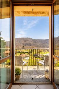 a view from a glass door of a balcony with chairs at La Terrazza delle Colline in Brunello