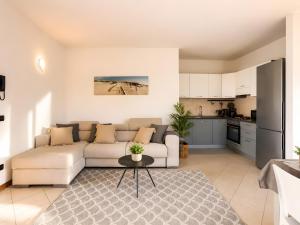 a living room with a couch and a kitchen at La Terrazza delle Colline in Brunello
