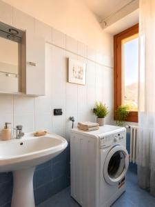 a bathroom with a washing machine and a sink at La Terrazza delle Colline in Brunello