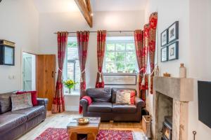 a living room with a couch and a fireplace at 2 Bed in Hexham oc-88032 in Bardon Mill