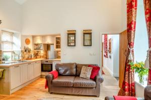 a living room with a couch and a kitchen at 2 Bed in Hexham oc-88032 in Bardon Mill