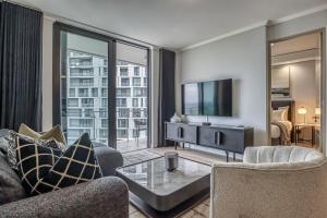 a living room with a couch and a tv at Stormside at Ellipse in Midrand