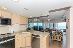 an open kitchen with a view of a dining room at Ilikai Tower 1314 in Honolulu