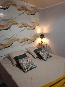 a bedroom with a bed with two pillows on it at Tortue marine in Saint-Benoît