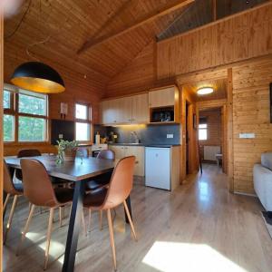 a kitchen and dining room with a table and chairs at Akureyri Cottages in Akureyri