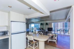 a kitchen and living room with a table and chairs at Ilikai Tower 1842 in Honolulu +19 photos