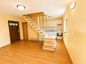 an empty living room with a staircase in a house at Digital Detox House Haloze in Podlehnik +10 photos