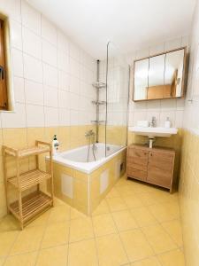 a bathroom with a tub and a sink at Digital Detox House Haloze in Podlehnik