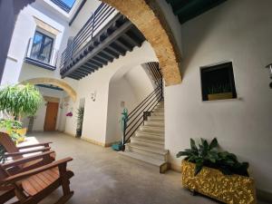 a hallway with a staircase in a building at CAMASanlúcar in Sanlúcar de Barrameda
