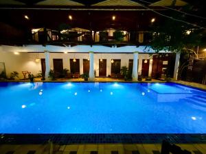 a large blue swimming pool at night at Oasis Bay - Arugam Bay in Arugam Bay +31 photos