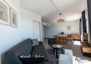 a living room with a couch and a table at Olydea Beausoleil in Beausoleil +10 photos