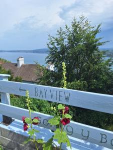 a white fence with a bay view written on it at Moon River in Goodwick