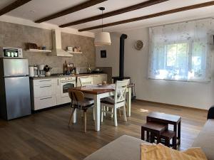 a kitchen with a table and chairs in a room at Kuća kod Fajdara in Vele Mune