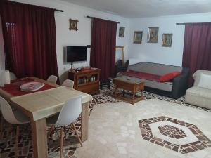 a living room with a couch and a dining room at Dabanović House in Virpazar