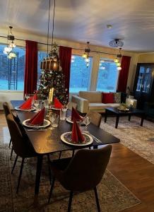 a living room with a table with a christmas tree at Villa Aurora in Rovaniemi