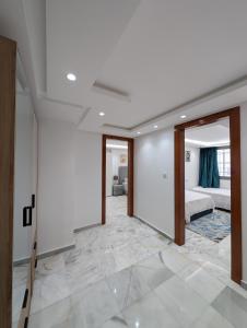 a bedroom with a king sized bed and a hallway at Tanger City 6 in Tangier