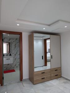 a room with two mirrors and a bathroom with a sink at Tanger City 6 in Tangier
