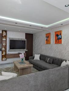 a living room with a couch and a tv at Tanger City 6 in Tangier