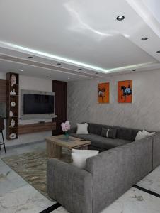 a living room with a couch and a tv at Tanger City 6 in Tangier +14 photos