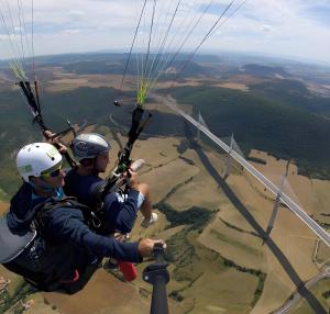 two people are flying in a parachute at gite millau in Millau +3 photos