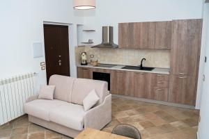 a living room with a couch and a kitchen at Borgo Izzo 2 in San Fele