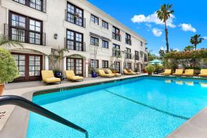 a swimming pool in front of a building at Best Western Plus Sunset Plaza Hotel in Los Angeles