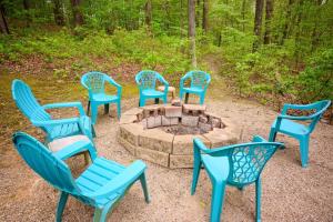 a group of blue chairs around a fire pit at Tree-Top Chalet in Logan