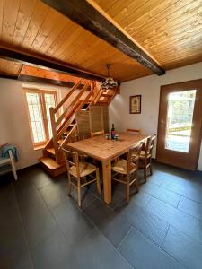a dining room with a wooden table and chairs at Casa Onsernone in Comologno in Comologno