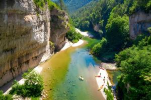 a view of a river with people rafting on it at gite millau in Millau