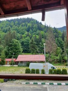 a white van parked in front of a mountain at Gutza Family in Cumpăna