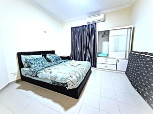 a bedroom with a bed and a dresser and a window at Desaru Coastline Cribs in Bandar Penawar +29 photos