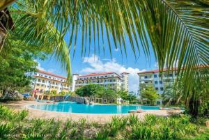 a view of a resort with a swimming pool at Desaru Coastline Cribs in Bandar Penawar