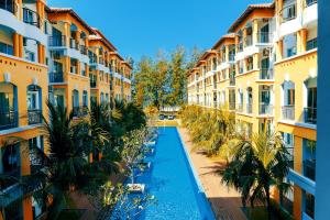 an aerial view of a swimming pool between two buildings at Desaru Coastline Cribs in Bandar Penawar