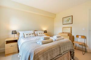 a bedroom with a large bed with towels on it at 3 Bed in Hawes oc-ds967 in Hawes