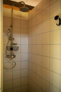 a shower in a bathroom with white tiles at Bikers camp in Poreč