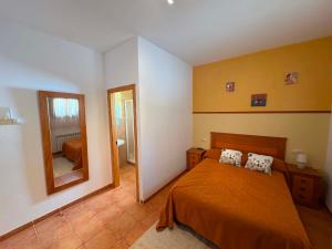 a bedroom with a bed and a large mirror at Casa Rural Tronchon in Tronchón
