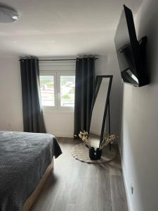 a bedroom with a bed and a mirror and a window at Apartment in Amer in Amer
