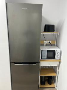 a kitchen with a refrigerator and a microwave at Apartment in Amer in Amer