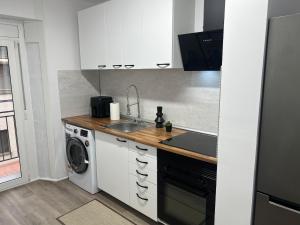a kitchen with a sink and a washing machine at Apartment in Amer in Amer +12 photos