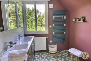 a bathroom with a sink and a mirror at L'orée du bois in Ploumagoar +59 photos