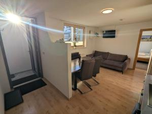 a living room with a table and chairs and a couch at Appart Gfall in Ried im Oberinntal